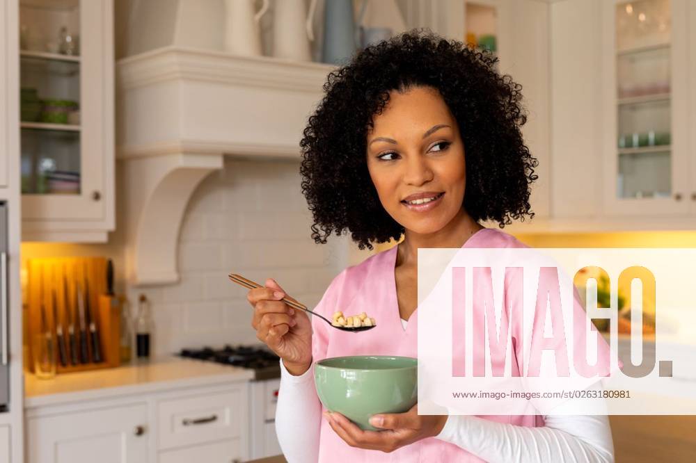 Happy biracial female medical worker in scrubs eating bowl of breakfast cereal in kitchen at home Happy biracial female medical worker in scrubs eating bowl of breakfast cereal in kitchen at home. Medical services, food, lifestyle and domestic life, unaltered., model released, , property released, Cape Town, South Africa, 2023-03-22T22:00:00.000Z, 4106208.jpg, people,happy biracial,female,medical worker,scrub,eating,bowl,breakfast,cereal,kitchen,home,service,food,lifestyle,domestic life,unaltered,meal,cooking,healthy,delicious,fresh,diet,nutrition,drink,tasty,ingredient,organic,dinner,table,lunch,gourmet,vegetarian,cuisine,snack,restaurant,sweet,happy,biracial,medical,worker,domestic,life Young Adult,Woman,Female,Multiracial