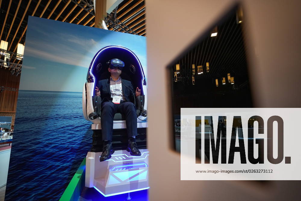 Delegate Dae Ho Son, of Hanwha Ocean, navigates a virtual reality LNG ship at the Qatar Energy booth during the LNG2023 conference, in Vancouver, B.C., Monday, July 10, 2023. VANCOUVER CANADA - ZUMAc35_ 20230710_zaf_c35_128