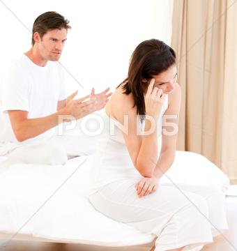 Angry couple having an argument sitting on their bed 30s,Mid Adult,Man,Caucasian,20s,Young Adult,Woman,Affronted,Annoyed,Argument,Bed,Bedroom,Bereaved,Bitter,Boyfriend,Couple,Depressed,Despairing,Despondent,Disconsolate,Dismal,Displeased,Distressed,Divorce,Exacerbated,Exasperated,Girlfriend,Gloomy,Glum,Heterosexual,Home,Husband,Indoors,Infuriated,Interiors,Irascible,Irate,Ireful,Irritable,Lovers,Low-spirited,Married,Melancholy,Morbid,Mournful,Offended,Pessimistic,Relationship,Resentful,Riled,Troubled,Unhappy,Valentine,Vexed,Wife,Adult