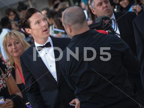 cast member benedict cumberbatch arrives for the premiere of the fifth estate at the 38th toronto international film festival on september 5, 2013. the movie is based on the true-life story of wikileaks founder julian assange. 2013, actors, canada, carpet, celebrity, cinema, crowd, editorial, entertainment, event, famous, fans, festival, film, film festival, hollywood, movie, people, photo, photocall, premier, premiere, red, september, star, tiff, toronto