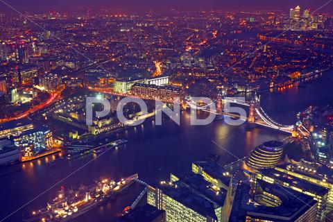 London rooftop view panorama at sunset with urban architectures and the tower bridge with thames river at night aerial, architecture, attraction, beautiful, bridge, britain, british, building, city, cityscape, england, english, europe, famous, historic, historical, history, kingdoms, landmark, old, outdoors, panorama, panoramic, river, rooftop, skyline, street, thames, tower, travel, uk, united, urban