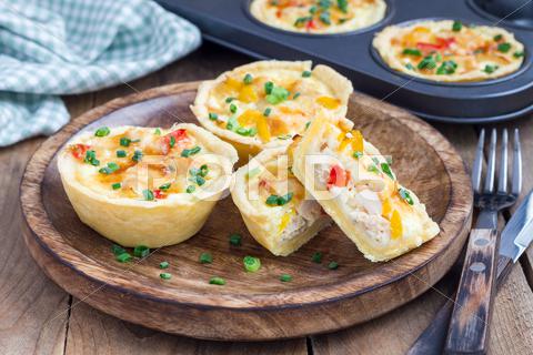 Mini quiche with chicken and bell pepper on a wooden plate appetizer, baked, bel, breakfast, brunch, cheese, chicken, closeup, cook, cream, dairy, delicious, dinner, dish, dough, easy, eat, egg, food, french, golden, healthy, herb, homemade, ingredient, kitchen, lorraine, lunch, meal, meat, mini, muffin, novel, onion, paprika, party, pepper, picnic, pie, plate, protein, quiche, savory, serving, small, snack, starter, table, tasty, wooden