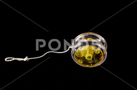 Close-up of yoyo yo-yo Object on a Black Background yoyo, yo-yo, white, object, background, isolated, single, equipment, color, technology, nobody, old, image, studio, macro, one, closeup, vintage, close-up, photography, shot, modern, horizontal