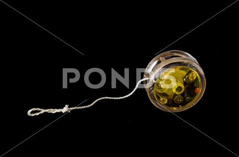 Close-up of yoyo yo-yo Object on a Black Background yoyo, yo-yo, white, object, background, isolated, single, equipment, color, technology, nobody, old, image, studio, macro, one, closeup, vintage, close-up, photography, shot, modern, horizontal