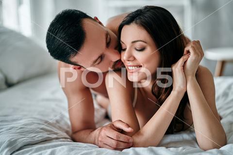 All photos are made of RAW output.We use hi-end cameras and lenses to get perfect quality.We've got videos similar to photos from our shootings. couple, sex, kissing, woman, man, relationship, love, passion, bed, relax, erotic, bedroom, home, beautiful, romance, people, sexy, happy, girl, lying, sexual, intimacy, naked, nude, holiday, body, prelude, play, pose, lay, white, boyfriend, morning, husband, desire, hands, linens, young, beauty, hug, foreplay, honeymoon, apartment, rest, two, adult, girlfriend, teeth, smile, cheerful