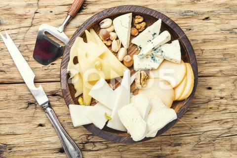 Cheese on the table.various types of cheese on old rustic wooden table different, cheese, piece, nut, kinds, assorted, slice, snack, healthy, cutting, appetizer, delicatessen, product, fresh, cut, parmesan, tasty, italian, cheddar, meal, food, brie, swiss, breakfast, assortment, milk, hole, eating, dairy, part, portion, holland, knife, set, dinner, tray, plate, cheese board, cheese platter, flavor, sliced, piece cheese, wooden, wooden table