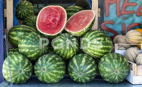 Watermelons on shelf. Cutted watermelon on street market. Summer Fruits. watermelon, supermarket, fruit, farm, melon, shop, bazar, fruits, retail, marketplace, fresh, market, food, shelf, organic, background, store, red, diet, freshness, ripe, sweet, nutrition, natural, summer, juicy, grocery, raw, water, delicious