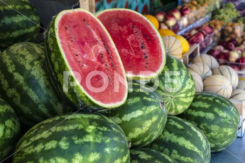 Watermelons on shelf. Cutted watermelon on street market. Summer Fruits. watermelon, supermarket, fruit, farm, melon, shop, bazar, fruits, retail, marketplace, fresh, market, food, shelf, organic, background, store, red, diet, freshness, ripe, sweet, nutrition, natural, summer, juicy, grocery, raw, water, delicious