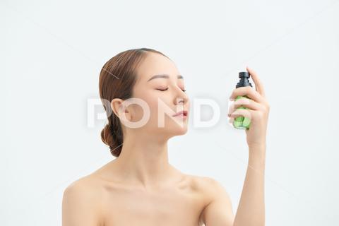 Beautiful asian woman applying spray water on face isolated white background. spaying, care, fresh, healthy, face, water, portrait, health, spray, thermal, white, beautiful, freshness, bottle, skin, young, beauty, woman, background, applying, treatment, person, closeup, girl, spa, natural, product, model, asian, vietnamese, korean, japanese, chinese