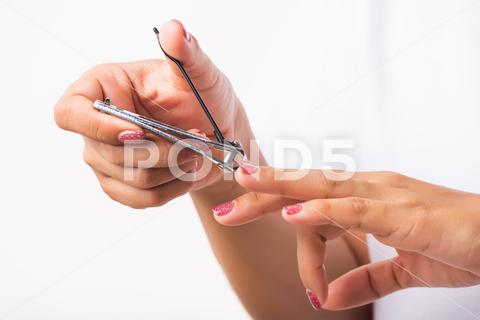 Close up young Asian woman have tool cutting nails fingernails on finger using a nail clipper. Female using tweezers by herself, studio shot isolated on white background, Healthcare concept nail, clipper, clip, cut, fingernail, human, hand, shorten, woman, trim, finger, tool, toenails, healthcare, adult, hands, fingers, people, girl, healthy, accessory, female, isolated, cutout, clean, instrument, clippers, health, young, thai, asian, care, beauty, manicure, closeup, hygiene, scissors, person, stainless, steel, body, cosmetics, skin, object, trimmer, metal, trimming, beautiful, equipment, white