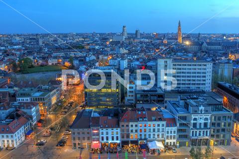 Aerial view over the city of Antwerp in Belgium from the MAS tower at twilight time. antwerp, belgium, belgian, skyline, aerial, twilight, dusk, houses, blue hour, old town, cathedral, landmarks, architecture, above, bird eye, panoramic, europe, european, red light district, mas tower, view, vista, vantage point, sky, streets, restaurants, benelux