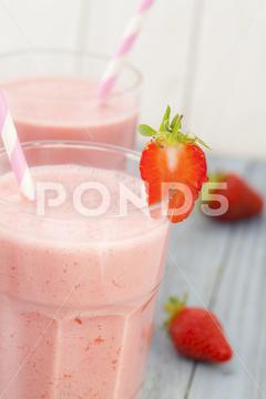 A shallow focus shot of delicious strawberry smoothie - healthy lifestyle concept fruit, food, berry, fresh, diet, cocktail, strawberry, healthy, drink, delicious, sweet, background, vitamin, refreshment, nutrition, fruits, tasty, dessert, summer, juicy, pink, ripe, snack, white, ice, shake, breakfast, gourmet, slice, cold, milkshake, beverage, eat, bright, health, juice, freshness, milk