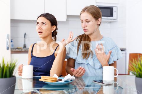 Portrait of upset young women discussing, quarrel during drinking tea at home kitchen woman, conflict, consoling, depression, quarrel, talk, table, adult, girlfriends, ordinary, people, young, meeting, portrait, sitting, togetherness, women, home, cheerful, indoors, tea, cup, house, european, american, 30s, 25-30, together, friends, beautiful, indoor, kitchen, friendship, two, attractive, conversation, communion, angry, talking, quarreling, problems, dialogue, unhappy, worried