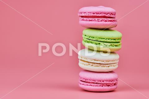 Macaroons on pink background. Colorful small cookie from ground almonds and coconut. Popular confectionery. Tasty snack food for take away, copy space macaroons, macaroon, macaron, pink, colorful, confectionery, cookie, popular, copy space, cake, pastry, cupcake, shortcake, tasty, food, design, snack, take, away, ground, almonds, coconut, small, red, studio, bunch, green, beige, dessert, pastel, different, assorted, cuisine, cafe, vintage, bakery, candy, sweet, french, sandwich, color, desert, sweetness, honey, goody, flavor, gourmet, breakfast, delicious, column