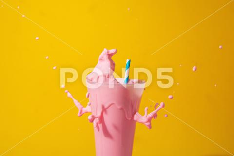 A glass of strawberry smoothie isolated on yellow and pink background fruit, diet, berry, strawberry, drink, healthy, nutrition, food, fresh, blended, vitamin, milkshake, background, summer, smoothie, sweet, dessert, refreshment, juicy, juice, glass, pink, isolated, straw, beverage, horizontal, yellow