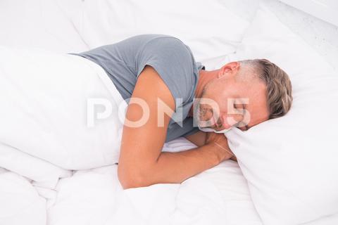 Relaxed man. Promote prevention and management of sleep disorders. World Sleep Day. Benefits of good and healthy sleep. Breathe Easily, Sleep Well. Handsome man in bed. Sleeping guy at home. sleeping, relaxed, man, home, sleep, sleepy, asleep, healthy, promote, prevention, management, disorders, world, benefits, good, breathe, easily, well, handsome, bed, guy, adult, concept, drowsy, face, fall, feel, get up, lying, morning, pillow, problems, relax, relaxation, rest, sleep disorder, techniques, time, tired, try, unshaven, wake up, wakefulness, handsome man, healthy sleep, sleeping man, bedroom, alone