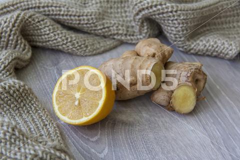 Ginger and lemon. Season of colds and infections. Strengthening the immune system with vitamins. Lemon, tea, ginger, season, cold, infection, covid, coronavirus, strengthening, immunity, performance, disease, substance, virus, prevention, nature, cold, flu, drink, concept, cute, care, medicine, pneumonia, close-up, spices, heat, vitamin, warning, juicy, winter, doctor, liquid, infectious, frost, SARS, scarf