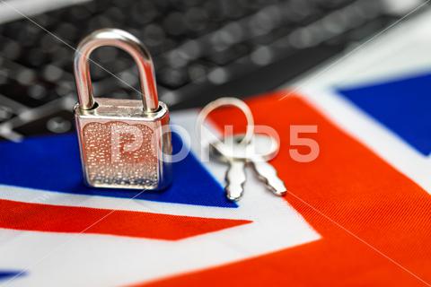 United Kingdom cyber security concept. Padlock on computer keyboard and UK flag. Close-up view united kingdom, computer, security, padlock, flag, lock, cybersecutiry, data, business, internet, protection, technology, concept, information, privacy, secure, safety, network, access, unlock, safe, cyber, digital, password, web, online, system, laptop, protect, key, communication, code, person, screen, crime, firewall, hacker, hand, intelligence, people, private, symbol, tech, fraud, hacking, background, connection, identity, human, cybercrime