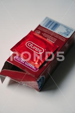 A vertical shot of red Durex brand condoms in a box box,brand,care,condoms,contraception,contraceptive,durex,healthy,plastic,protection,red,safety,sex,vertical