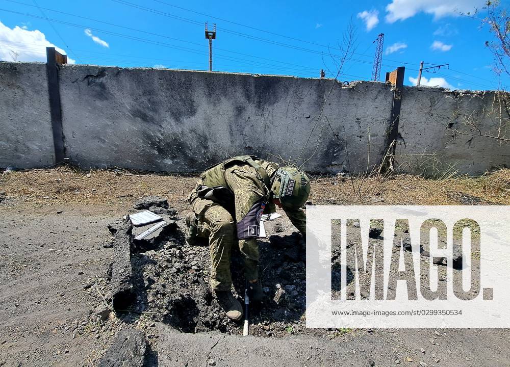 Russia Ukraine Military Operation Shelling 8479530 16.07.2023 A member of the DPR mission to the Joint Center for Control and Coordination (JCCC) on issues related to Ukraine s war crimes inspects a crater left by a missile after a recent shelling by Ukrainian forces, in the course of Russia s military operation in Ukraine, in Donetsk, Donetsk People s Republic, Russia. RIA Novosti Sputnik Donetsk Donetsk People s Republic Russia