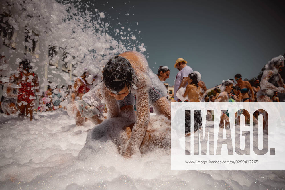 Tow boys wrestle in foam as they participate in a foam party looking for some refreshment during the traditional Sant Bartomeu Festival while the island is on orange alert for high temperatures in just another heatwave. Es Mercadal Spain - ZUMAo105 20230717_fap_o105_024