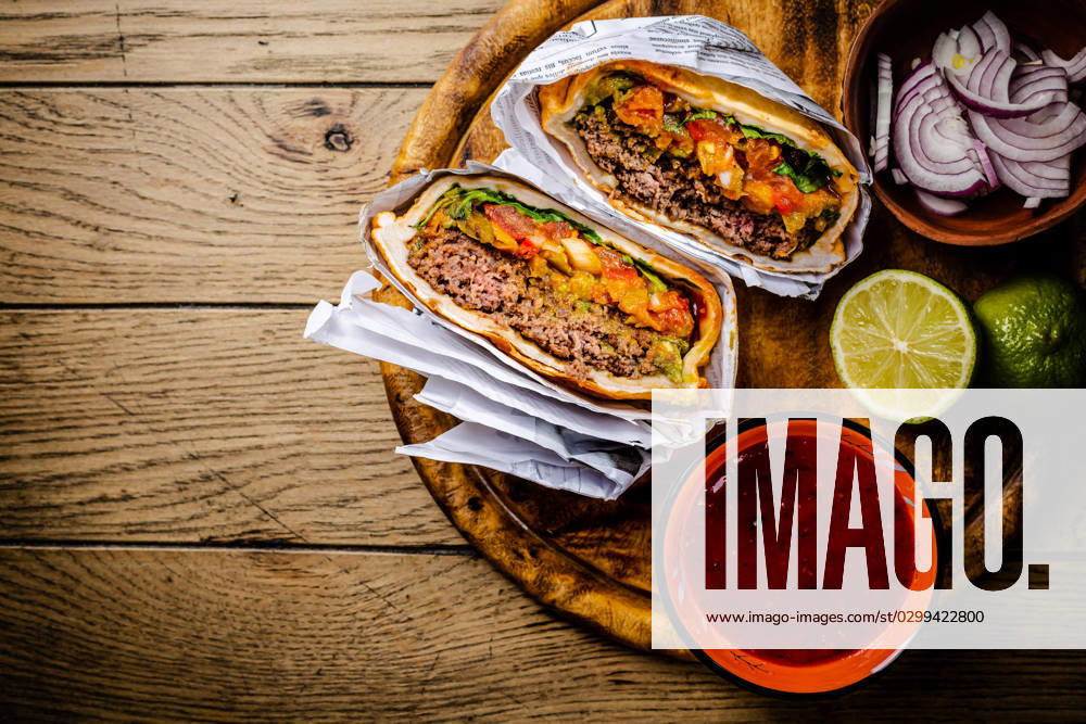 Hamburger or sandwich Hamburger or sandwich, beef torta with salsa dip and guacamole. Mexican cuisine.