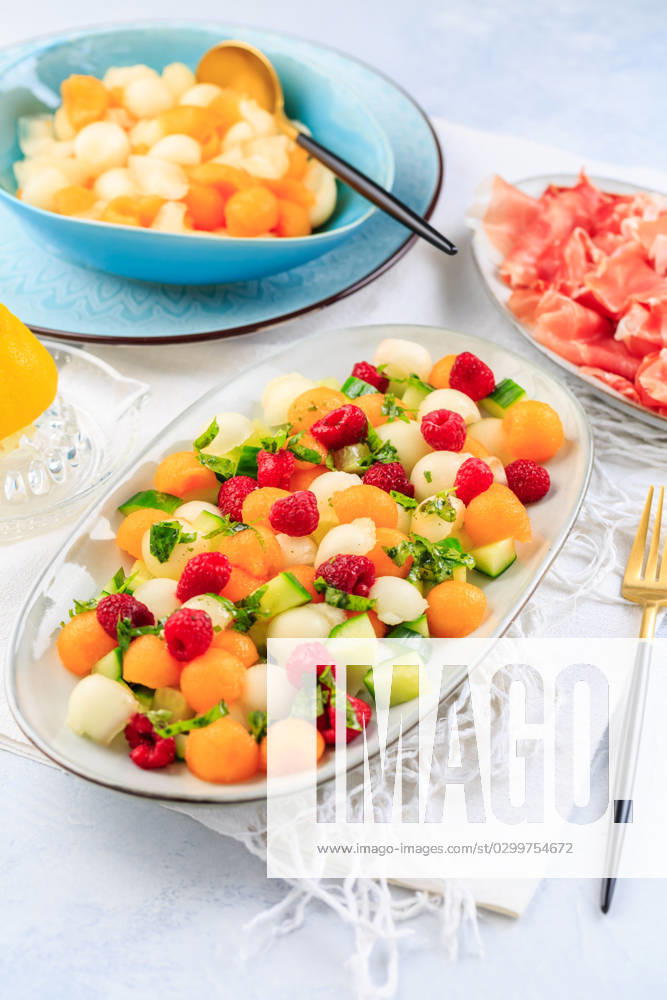 Summer light food. Cucumber and melon salad with raspberries and Prosciutto and pickled hot peppers Summer light food. Cucumber and melon salad with raspberries and Prosciutto and pickled hot peppers