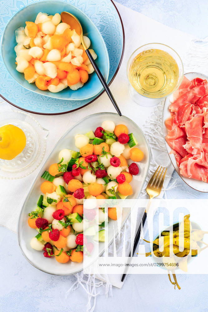Summer light food. Cucumber and melon salad with raspberries and Prosciutto and pickled hot peppers Summer light food. Cucumber and melon salad with raspberries and Prosciutto and pickled hot peppers