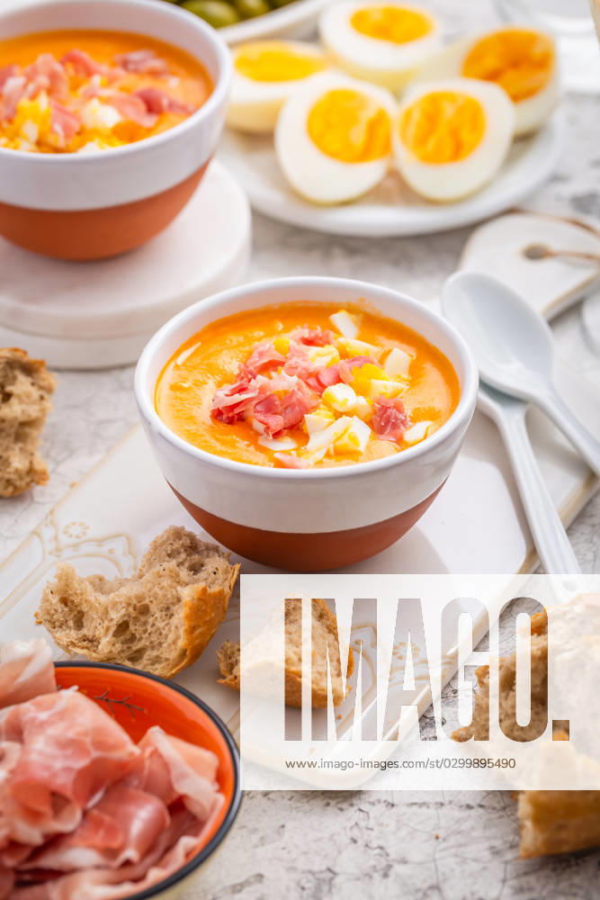 Salmorejo - raw tomato soup with ingredients on a kitchen table Salmorejo - raw tomato soup with ingredients on a kitchen table, spanish cuisine for hot summer