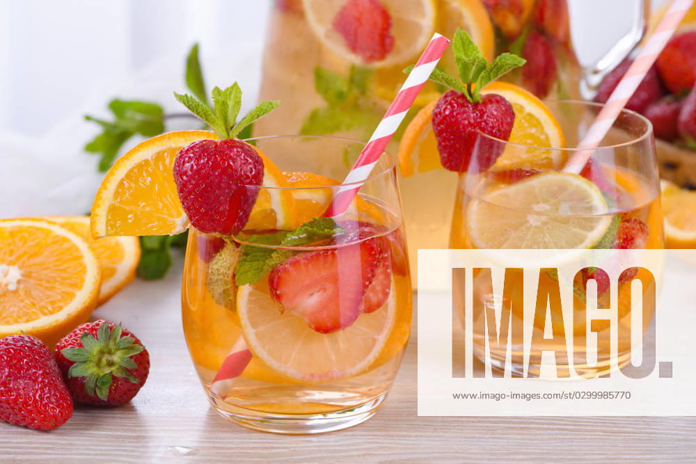 Summer Sangria cocktail Summer Sangria cocktail or lemonade with strawberry, orange and mint. Refreshing organic non-alcoholic, Detox vitaminized healthy drink, fruit in a glass