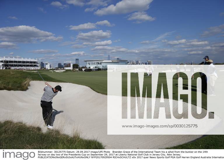 Branden Grace of the International Team his a sjhot from the bunker on the 14th fairway on day two of the Presidents Cup on September 29, 2017 at Liberty National Golf Club in Jersey City, New Jersey. NYP20170929504 RICHxSCHULTZ