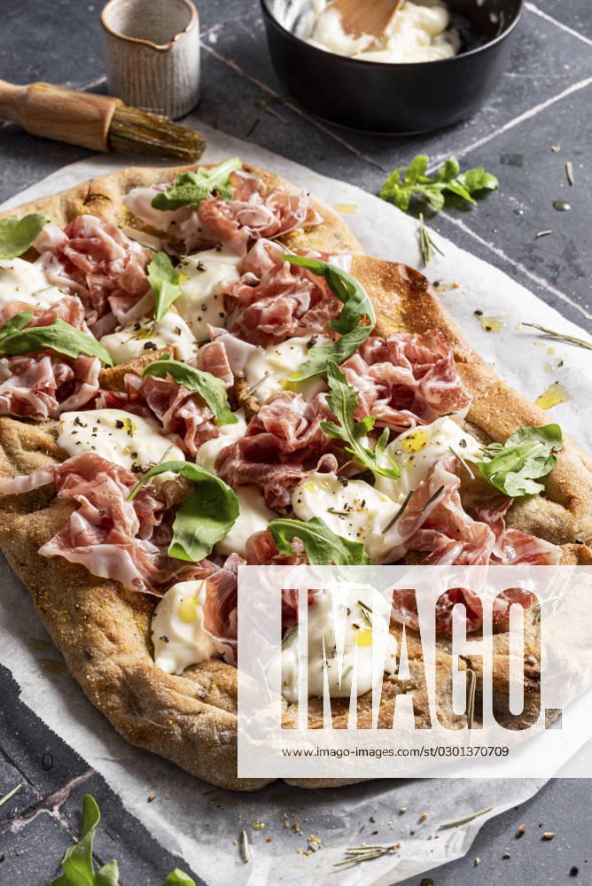 Pizza with prosciutto, arugula, cheese and olive oil Pizza with prosciutto, arugula, cheese and olive oil
