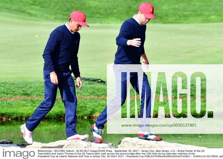 Jersey City, New Jersey, U.S - Rickie Fowler of the US Team(left)j and Justin Thomas of the US Team(right) walk across the stone bridge after the 12th hole during Saturday matches of the Presidents Cup at Liberty National Golf Club in Jersey City, NJ GOLF 2017 - Presidents Cup - ZUMAc119 20170930_zaf_c119_004