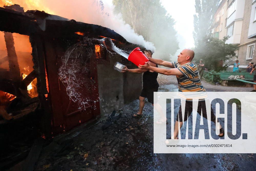 KW35 RUSSIA, DONETSK - AUGUST 31, 2023: A local resident battles a fire after a military strike on the village of Lidiyevka. According to Mayor of Donetsk Alexei Kulemzin, the Armed Forces of Ukraine have performed a military strike on the city s Kirovsky District, casualties reported. Dmitry Yagodkin TASS 61576489