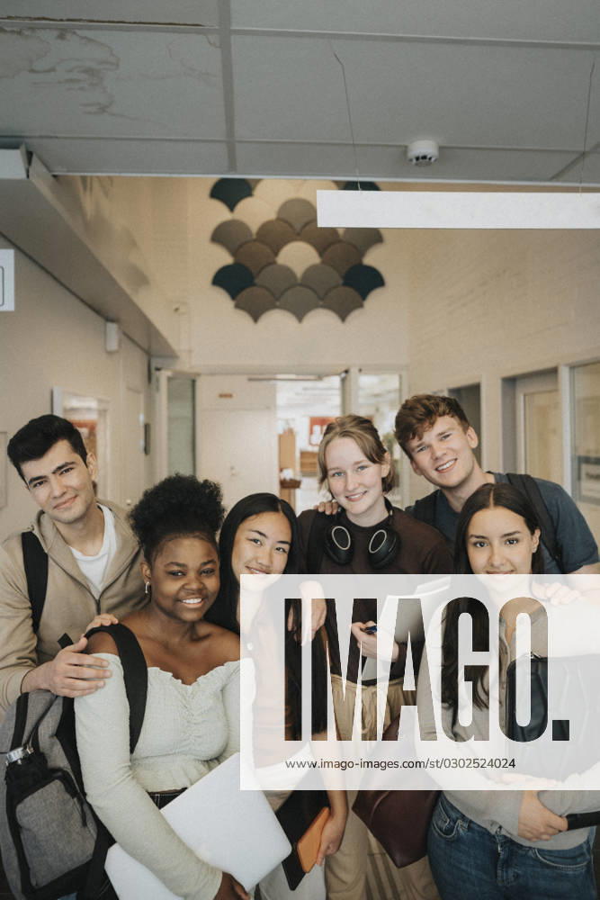 Portrait of happy multiracial male and female students at university Sweden, Gothenburg, model released, property released