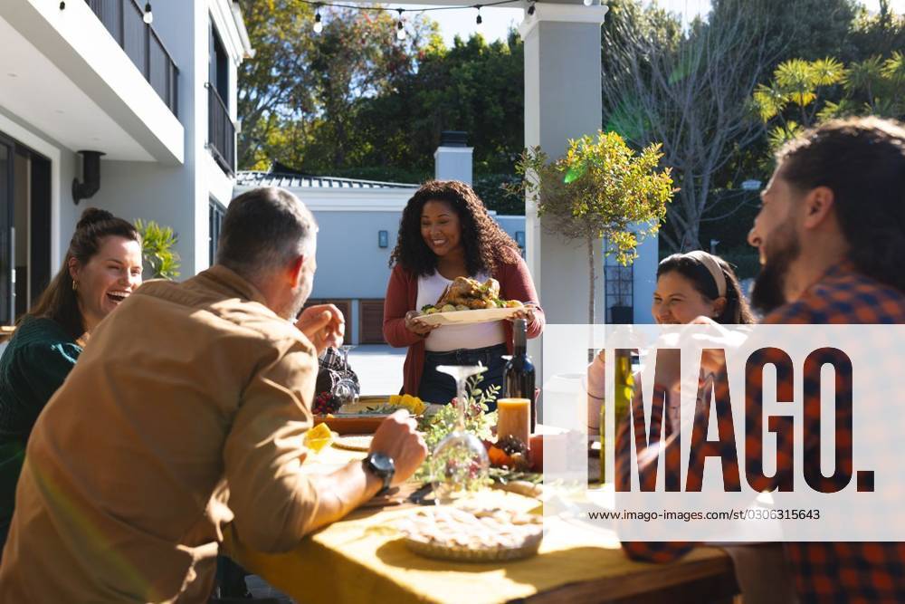 Happy diverse male and female friends serving thanksgiving celebration meal in sunny garden Happy diverse male and female friends serving thanksgiving celebration meal in sunny garden. Celebration, friendship, patriotism, american culture and tradition, unaltered., model released, , property released, Cape Town, South Africa, 07.09.2023, 4193332.jpg, people,happy,diverse,male and female,friend,serving,thanksgiving,celebration,meal,sunny,garden,friendship,patriotism,american culture,tradition,unaltered,holiday,patriotic,dinner,fun,nation,young,lunch,happiness,together,beautiful,spring,summer,party,food,traditional,season,christmas,cheerful,decoration,flag,male,female,american,culture Mid Adult,Man,Male,Black,Woman,Female,Multiracial,White,M