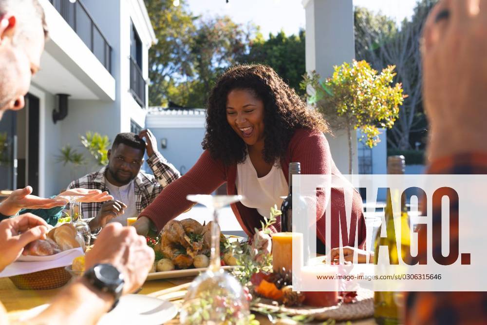 Happy diverse male and female friends serving thanksgiving celebration meal in sunny garden Happy diverse male and female friends serving thanksgiving celebration meal in sunny garden. Celebration, friendship, patriotism, american culture and tradition, unaltered., model released, , property released, Cape Town, South Africa, 07.09.2023, 4193333.jpg, people,happy,diverse,male and female,friend,serving,thanksgiving,celebration,meal,sunny,garden,friendship,patriotism,american culture,tradition,unaltered,holiday,patriotic,dinner,fun,nation,young,lunch,happiness,together,beautiful,spring,summer,party,food,traditional,season,christmas,cheerful,decoration,flag,male,female,american,culture Mid Adult,Woman,Female,African American,Mature Adult,Man,