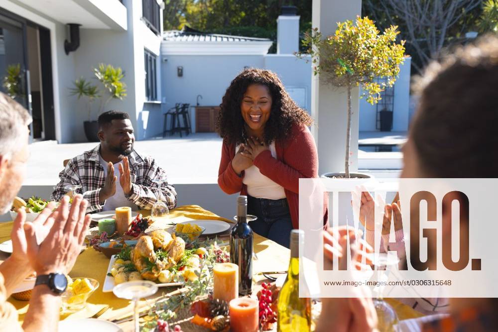 Happy diverse male and female friends serving thanksgiving celebration meal in sunny garden Happy diverse male and female friends serving thanksgiving celebration meal in sunny garden. Celebration, friendship, patriotism, american culture and tradition, unaltered., model released, , property released, Cape Town, South Africa, 07.09.2023, 4193334.jpg, people,happy,diverse,male and female,friend,serving,thanksgiving,celebration,meal,sunny,garden,friendship,patriotism,american culture,tradition,unaltered,holiday,patriotic,dinner,fun,nation,young,lunch,happiness,together,beautiful,spring,summer,party,food,traditional,season,christmas,cheerful,decoration,flag,male,female,american,culture Mid Adult,Woman,Female,African American,Mature Adult,Man,