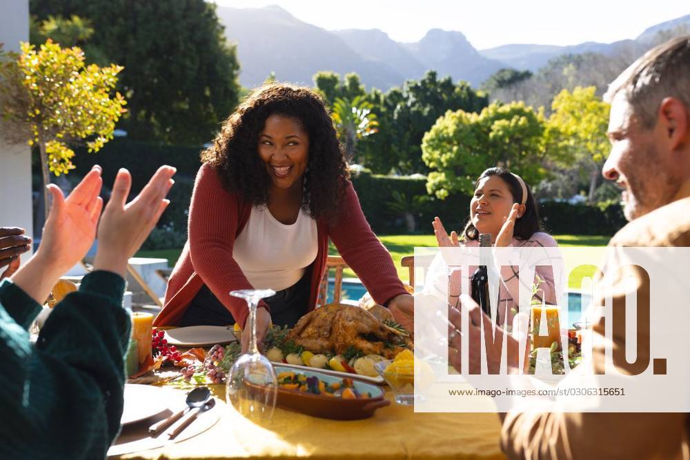 Happy diverse male and female friends serving thanksgiving celebration meal in sunny garden Happy diverse male and female friends serving thanksgiving celebration meal in sunny garden. Celebration, friendship, patriotism, american culture and tradition, unaltered., model released, , property released, Cape Town, South Africa, 07.09.2023, 4193335.jpg, people,happy,diverse,male and female,friend,serving,thanksgiving,celebration,meal,sunny,garden,friendship,patriotism,american culture,tradition,unaltered,holiday,patriotic,dinner,fun,nation,young,lunch,happiness,together,beautiful,spring,summer,party,food,traditional,season,christmas,cheerful,decoration,flag,male,female,american,culture Mid Adult,Woman,Female,African American,Mature Adult,Man,
