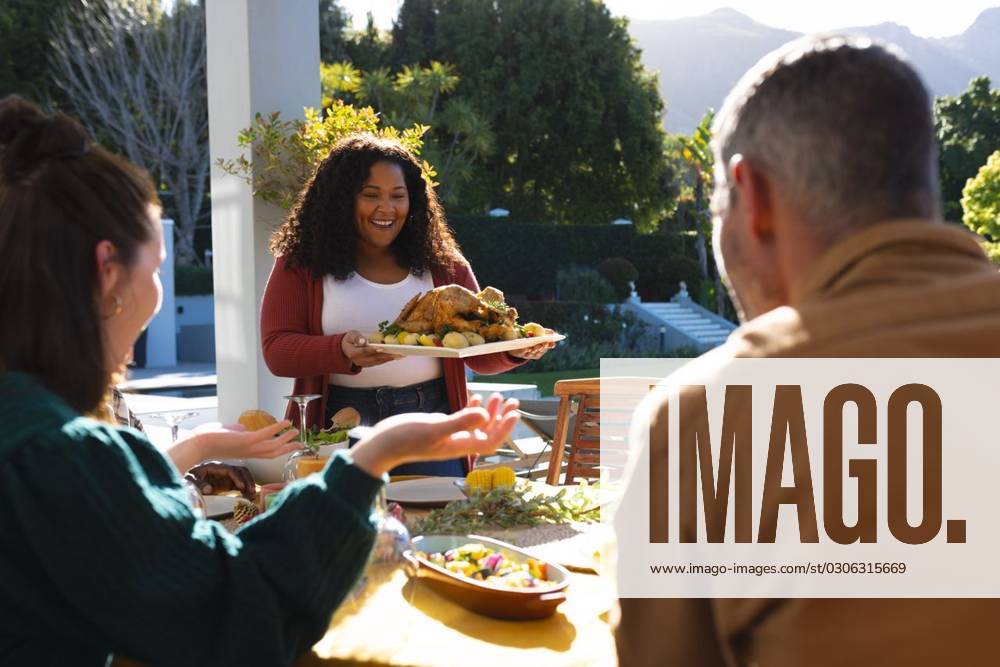 Happy diverse male and female friends serving thanksgiving celebration meal in sunny garden Happy diverse male and female friends serving thanksgiving celebration meal in sunny garden. Celebration, friendship, patriotism, american culture and tradition, unaltered., model released, , property released, Cape Town, South Africa, 07.09.2023, 4193342.jpg, people,happy,diverse,male and female,friend,serving,thanksgiving,celebration,meal,sunny,garden,friendship,patriotism,american culture,tradition,unaltered,holiday,patriotic,dinner,fun,nation,young,lunch,happiness,together,beautiful,spring,summer,party,food,traditional,season,christmas,cheerful,decoration,flag,male,female,american,culture Mid Adult,Woman,Female,African American,Mature Adult,Man,