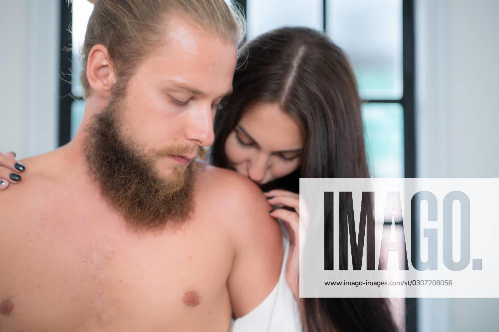 Handsome bearded man with long beard and pretty sexy woman with brunette hair in bedroom Handsome bearded man with long beard and pretty sexy woman with brunette hair in bedroom ,model released, Symbolfoto