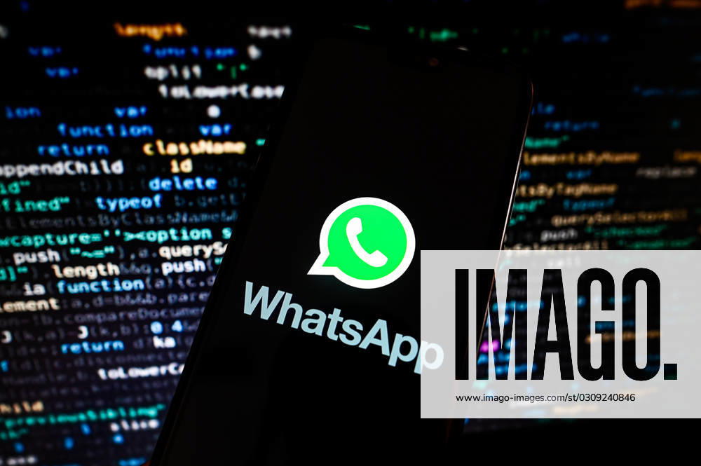 Tech illustrations in Poland - 18 Oct 2023 In this photo illustration a WhatsApp logo is displayed on a smartphone with programing codes on the background. economy, business, logo, logos, sign, brand, technology, online, smartphone, cellphone, mobile phone, phone, device Poland