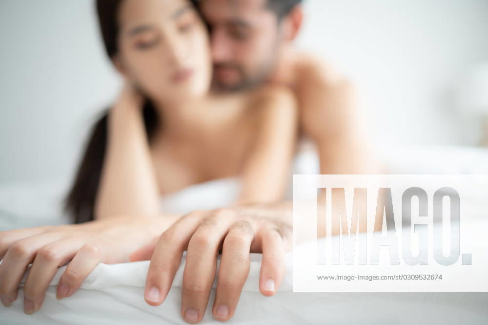 Gorgeous sexy couple enjoying arousing sex before having sex on bed in home bedroom The concept of emotional and love relationships. Gorgeous sexy couple enjoying arousing sex before having sex on bed in home bedroom The concept of emotional and love relationships. ,model released, Symbolfoto