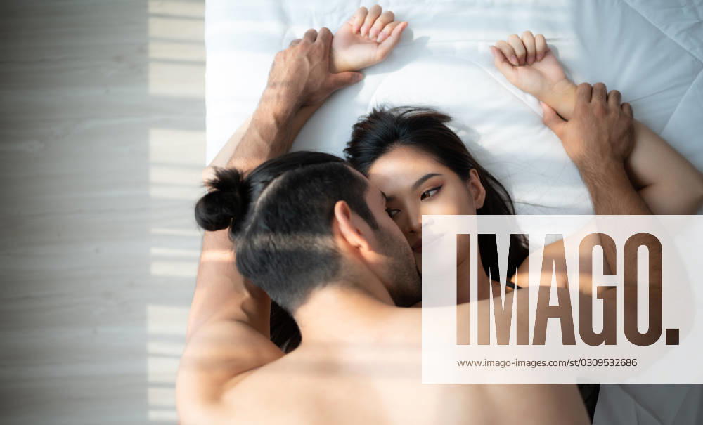 Gorgeous sexy couple enjoying arousing sex before having sex on bed in home bedroom The concept of emotional and love relationships. Gorgeous sexy couple enjoying arousing sex before having sex on bed in home bedroom The concept of emotional and love relationships. ,model released, Symbolfoto
