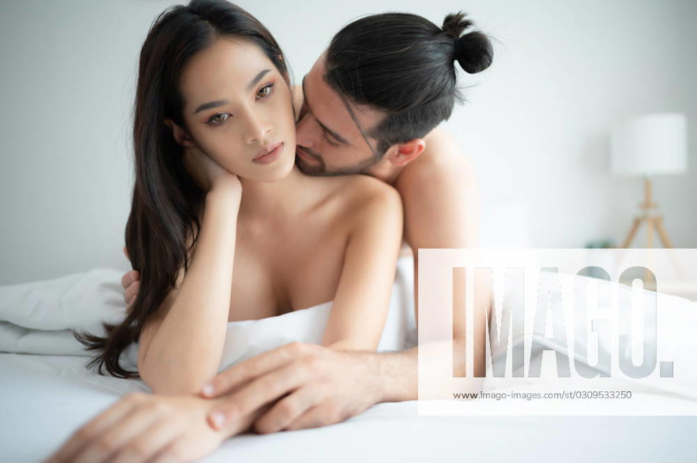 Gorgeous sexy couple enjoying arousing sex before having sex on bed in home bedroom The concept of emotional and love relationships. Gorgeous sexy couple enjoying arousing sex before having sex on bed in home bedroom The concept of emotional and love relationships. ,model released, Symbolfoto