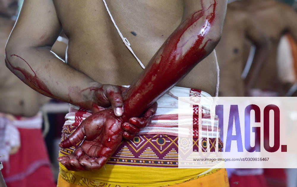 Blood stain in the hands of priest after sacrificing a buffalo during the Maha Navami of Durga Puja festival at Dileswar Devalaya ,Belsor in Nalbari district of Assam India on Monday 23rd October 2023 Guwahati India - ZUMAd163 20231023_zip_d163_009