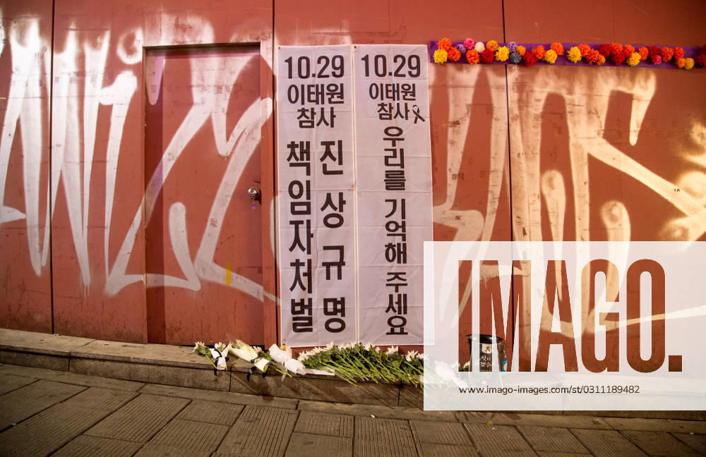 Itaewon tragedy, Oct 29, 2023 : Flowers are seen in alleyway, the site of the Itaewon crowd crush during Halloween celebrations last year, in Seoul, South Korea. Thousands of people and family members of the victims gathered in central Seoul on Sunday to cherish the memories of the deceased at a memorial event marking the first anniversary of the deadly Itaewon crowd crush that claimed 159 lives. They demanded a probe into the disaster and punishment of officials found responsible for the tragedy. Placards read, Investigate and punish officials found responsible for the October 29 Itaewon disaster (L) and Remember us . , aflo_234061662.jpg,