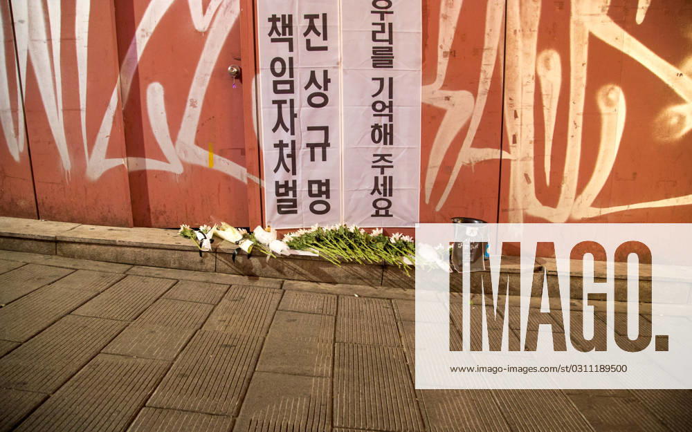 Itaewon tragedy, Oct 29, 2023 : Flowers are seen in alleyway, the site of the Itaewon crowd crush during Halloween celebrations last year, in Seoul, South Korea. Thousands of people and family members of the victims gathered in central Seoul on Sunday to cherish the memories of the deceased at a memorial event marking the first anniversary of the deadly Itaewon crowd crush that claimed 159 lives. They demanded a probe into the disaster and punishment of officials found responsible for the tragedy. Placards read, Investigate and punish officials found responsible for the October 29 Itaewon disaster (L) and Remember us . , aflo_234061678.jpg,