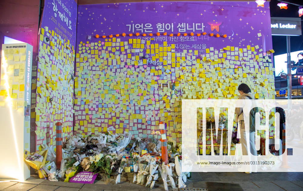 Itaewon tragedy, Oct 29, 2023 : A woman mourns for the perished in an alleyway, the site of the Itaewon crowd crush during Halloween celebrations last year, in Seoul, South Korea. Thousands of people and family members of the victims gathered in central Seoul on Sunday to cherish the memories of the deceased at a memorial event marking the first anniversary of the deadly Itaewon crowd crush that claimed 159 lives. They demanded a probe into the disaster and punishment of officials found responsible for the tragedy. , aflo_234062557.jpg,