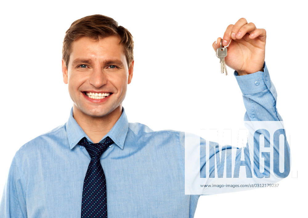 Portrait of smiling businessman holding keys isolated on white background